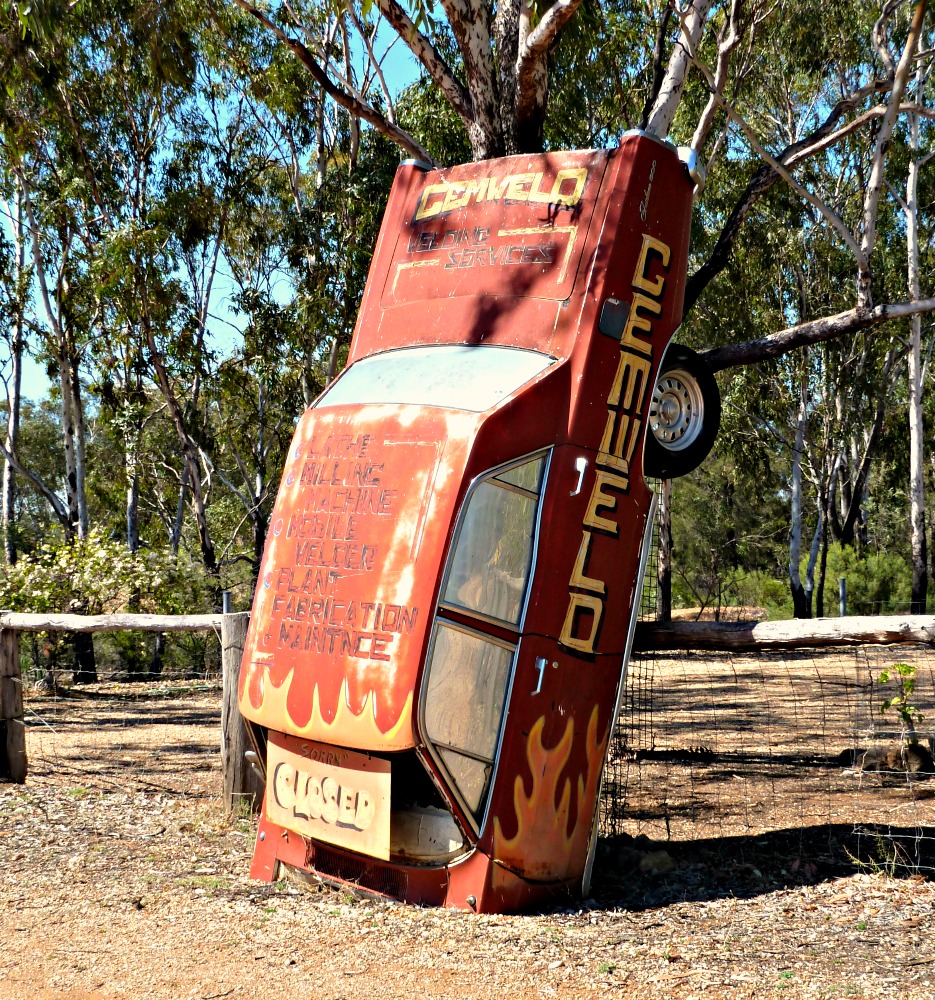 Funny australian sign on an old wrecked car